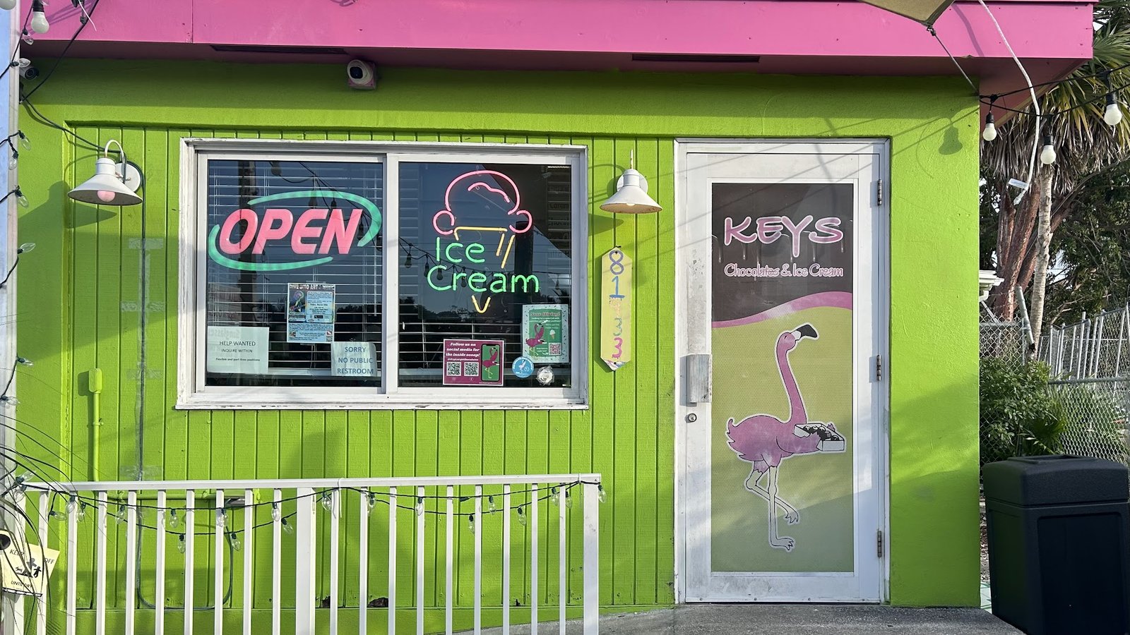 The Keys Chocolates Islamorada storefront on Mile Marker 81.9, with the pink and green facade and the KEYS Chocolates flamingo door