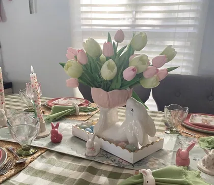 Easter centerpiece with sage eggs, florals and a bunny on a Miami dining table