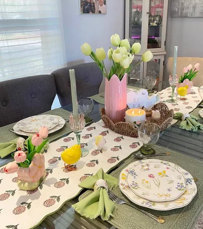 Spring table set with tulips, floral plates and green napkins