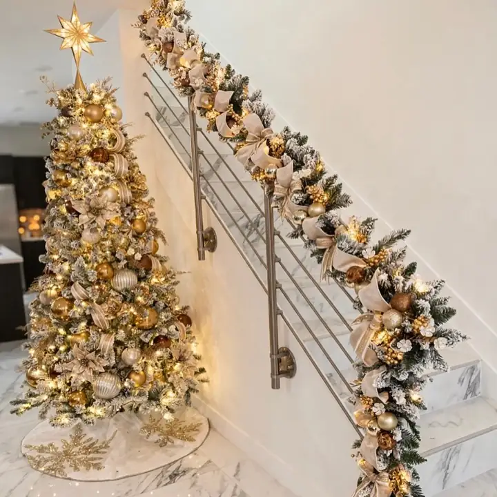 Full view of a gold staircase garland and the matching flocked tree