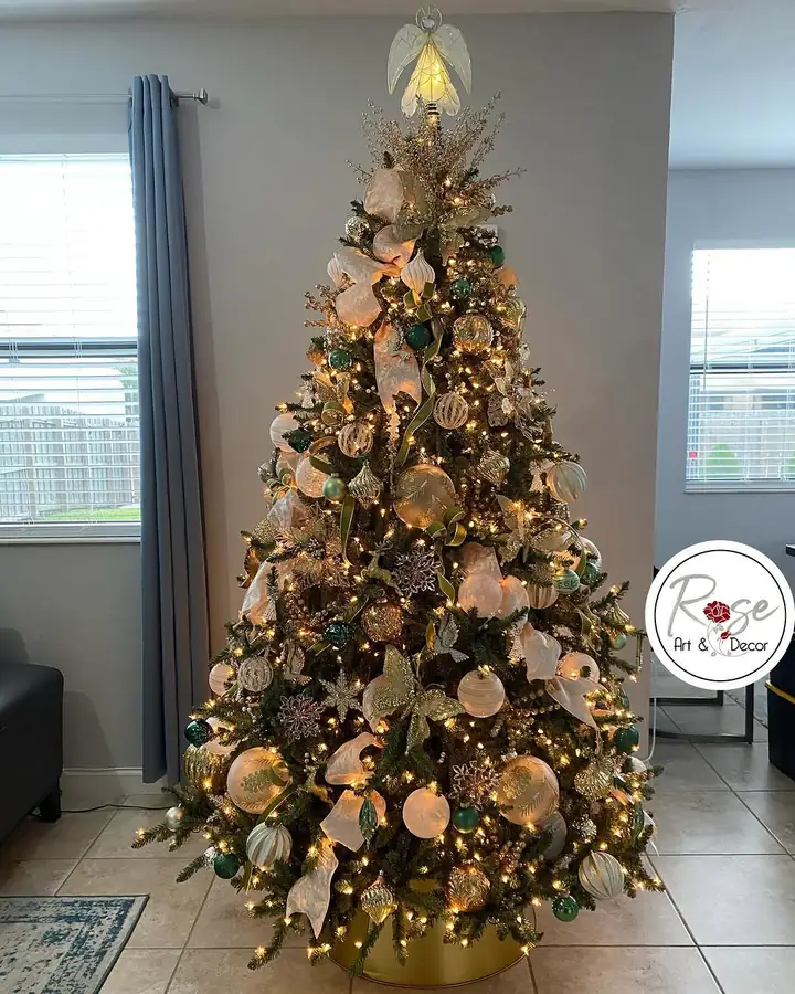 Gold, beige and green Christmas tree fully decorated in a Miami home