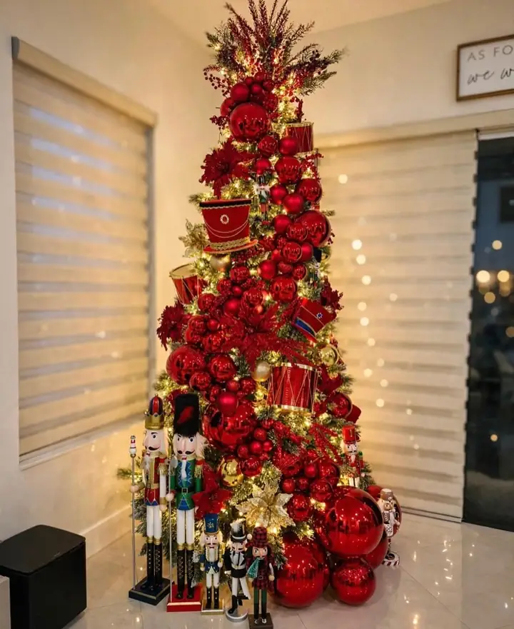 Drum ornaments and wide red ribbon on a commercial scale tree
