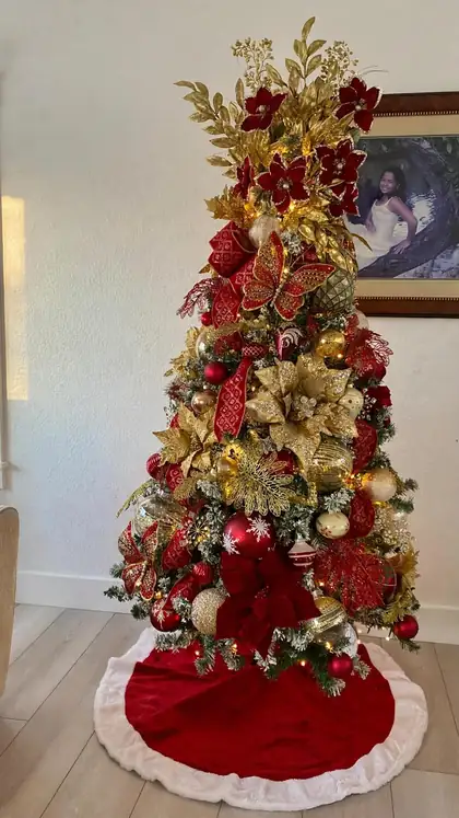 Classic red and gold Christmas tree with a velvet skirt