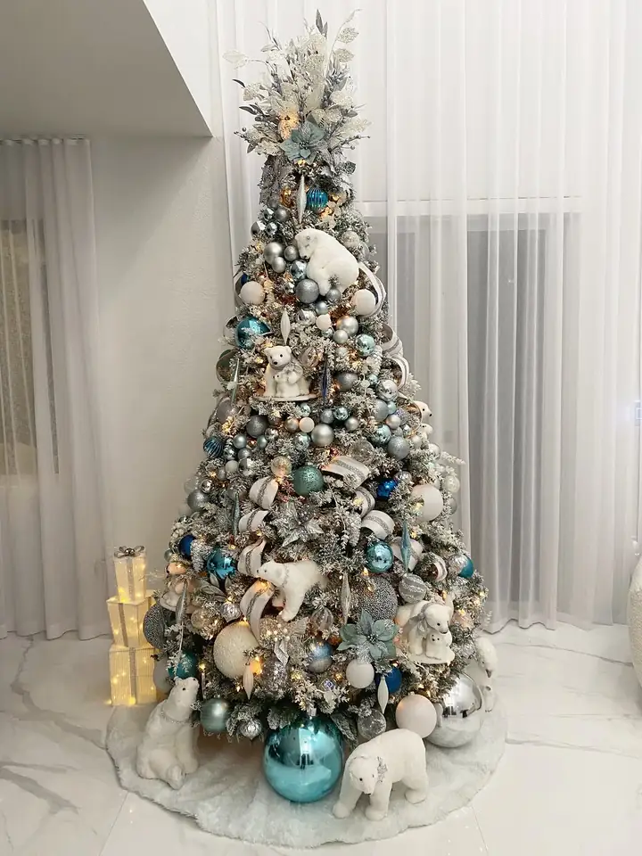Flocked white tree with icy blue ornaments and polar bears